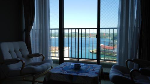 a room with a large window with a view of the water at Kishotei in Hirado