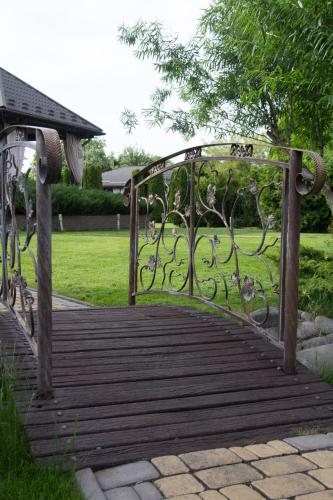 a wooden boardwalk with a gate in a park at Gorny Ruchej in Hora