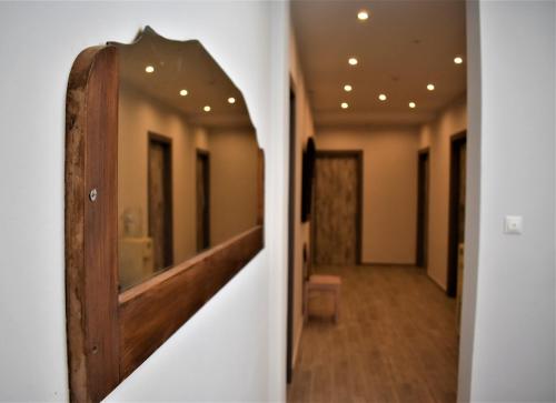 a hallway in a building with a mirror on the wall at Aphrodite Art Hotel Aegina in Egina