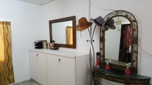 a dressing room with a mirror and a dresser at MYHome@Langkawi in Pantai Cenang