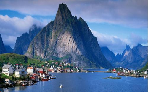a small town in front of a mountain at Peaceful Farm in Bøstad