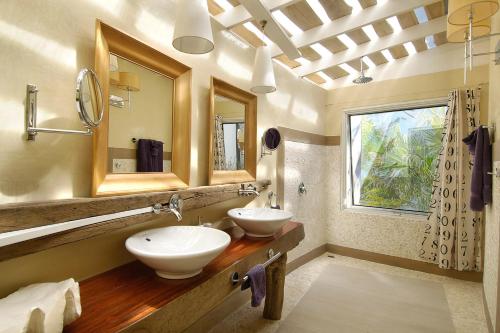 a bathroom with two sinks and a window at Villa Don Vito in Tamarindo