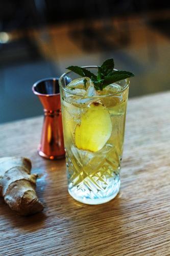 a drink with a lemon on a wooden table at ibis Paris Bercy Village in Paris