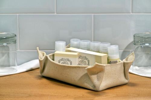 a bag filled with items on a table with jars at Hotel da Fábrica in Manteigas
