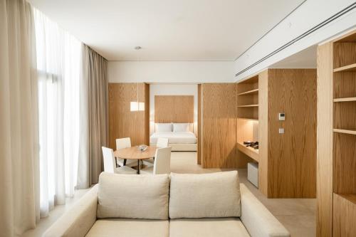 a living room with a couch and a bedroom at Delta Hotel Apartments in Kuwait