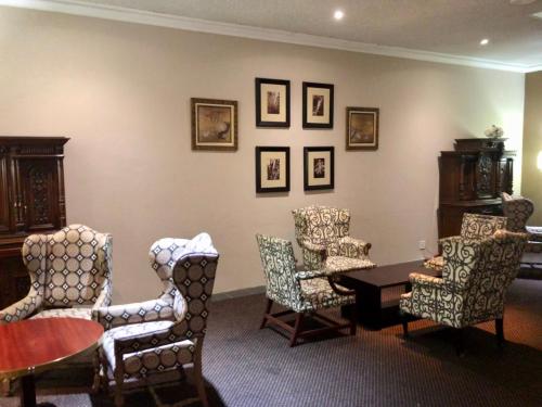 a dining room with chairs and a table and a tablektop at The Royal Hotel by Coastlands Hotels & Resorts in Durban