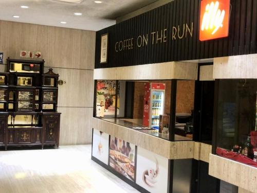 a coffee shop with a sign on the run at The Royal Hotel by Coastlands Hotels & Resorts in Durban