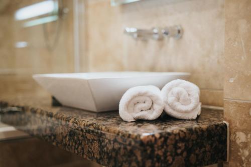 a bathroom with a sink and towels on a counter at Hall Farm Hotel And Restaurant in Ashby cum Fenby