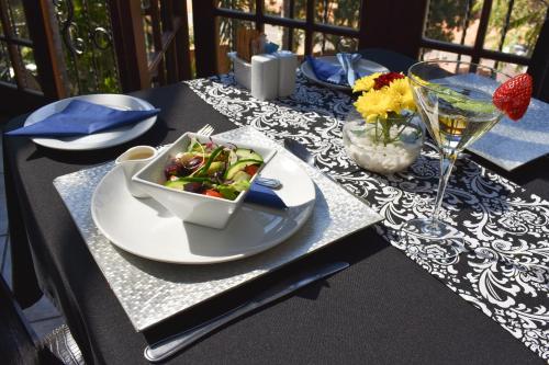 a table with a bowl of food on a table at Waterfalls Boutique Hotel in Pretoria