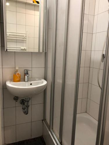 a bathroom with a sink and a shower at Pension Adler in Lübeck