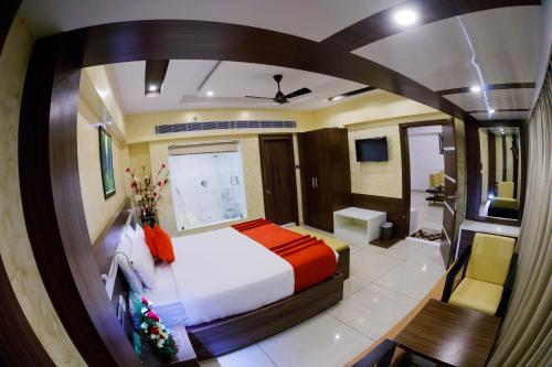 a bedroom with a large bed and a bathroom at The Renai Cochin in Cochin