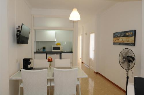une cuisine et une salle à manger avec une table et des chaises dans l'établissement Mini Golf Apartments, à Canyamel