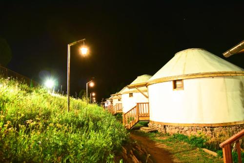 a round building with a dome on the side of a hill at Supara Chunkurchak in Alamedin