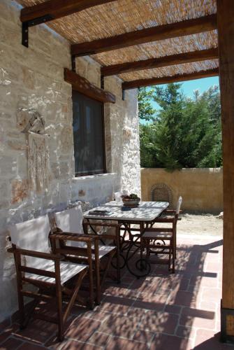 a patio with a table and chairs on a patio at LIORIZA Country Houses in Kalamaki