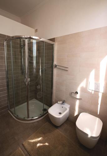 a bathroom with a shower and a toilet and a sink at Villa Liberty B&B in Fano