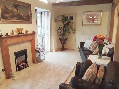 a living room with a couch and a fireplace at THE RETREAT in Hereford