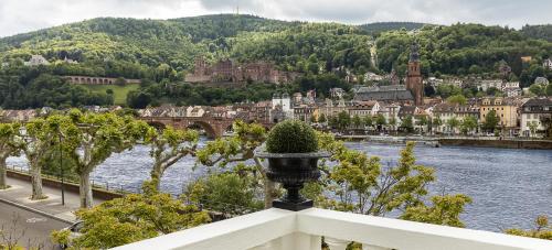 a view of a city with a river and a bridge at House of Hütter- Heidelberg Suites Boutique in Heidelberg