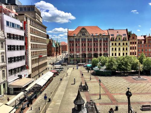 a city street with many tall buildings in a city at Solny Square Aparthotel in Wrocław
