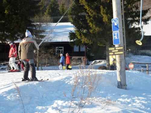 a person standing on skis in the snow at Chalupa Pri vleku. in Donovaly