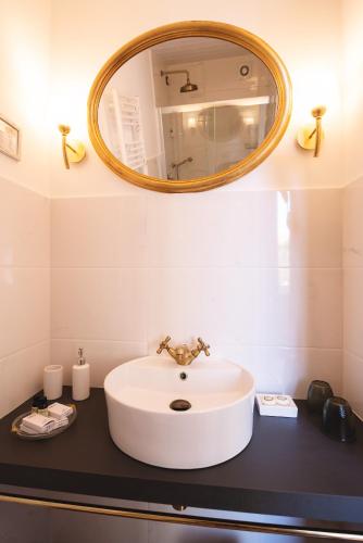 a bathroom with a white sink and a mirror at Villa Liberty B&B in Fano