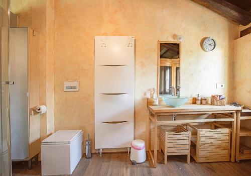 a kitchen with a white refrigerator and a sink at Casa del Bosco in Busca