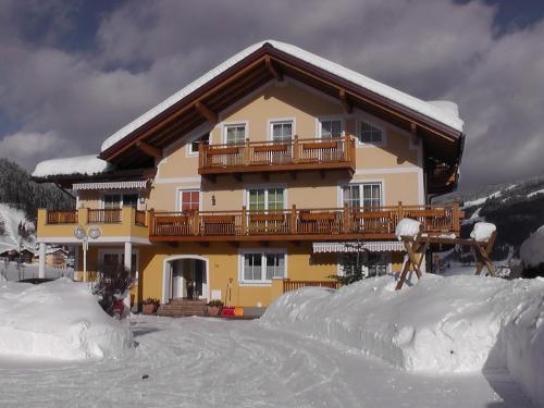 a snow covered house with a balcony in the snow at Haus Maier in Flachau