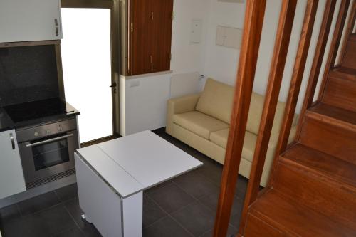 a small living room with a chair and a stove at Casa Madalena in Barão de São João