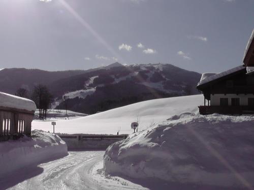 a snow covered road in front of a mountain at Haus Maier in Flachau