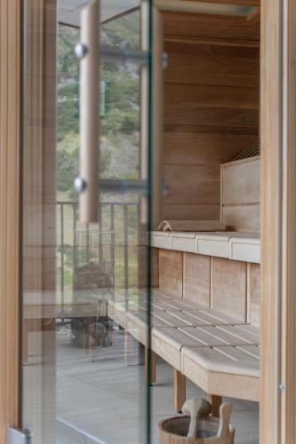 a room with a wooden bench and a window at Josl Mountain Lounging Hotel - Adults only! in Obergurgl