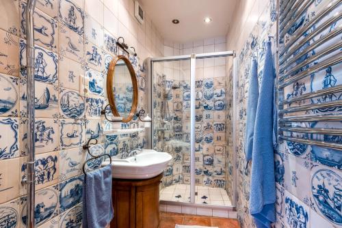 a blue and white bathroom with a sink and shower at Angel House Vilnius, Pilies in Vilnius