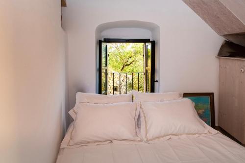 a bedroom with a bed with white pillows at PositiveSpace Olive Tree in Levktron