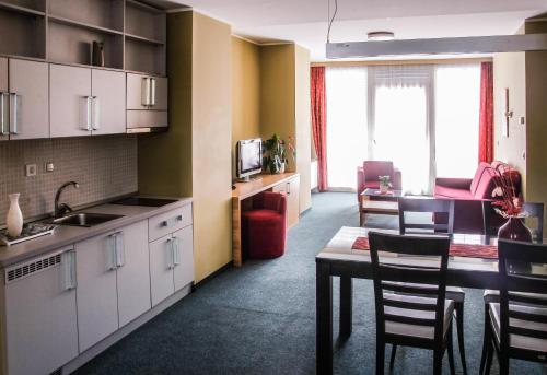 a kitchen and dining room with a table and chairs at Hotel Veter in Ruše