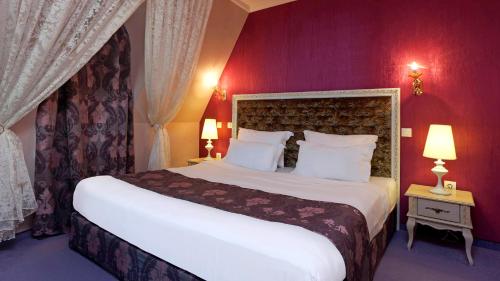 a bedroom with a large white bed with red walls at Kristel Hotel in St. St. Constantine and Helena