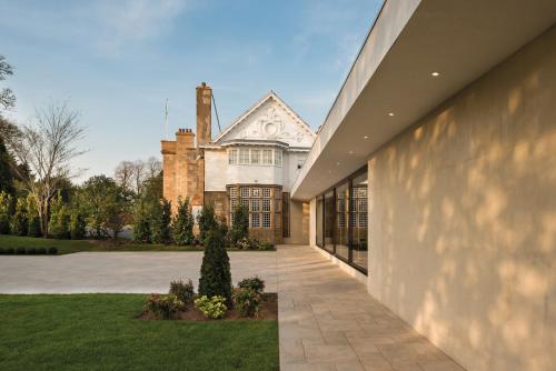an exterior view of a house with a driveway at Dalmeny Park House Hotel in Barrhead