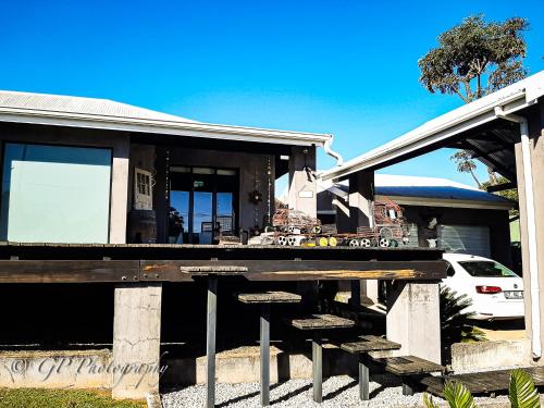 a house with a porch and steps to it at Laguna Lodge in Graskop