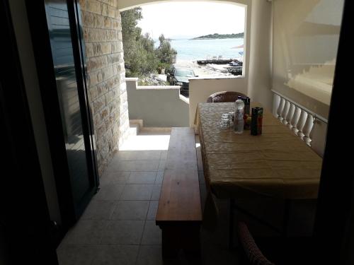 a table in a room with a view of the ocean at Holiday house Val in Pašman