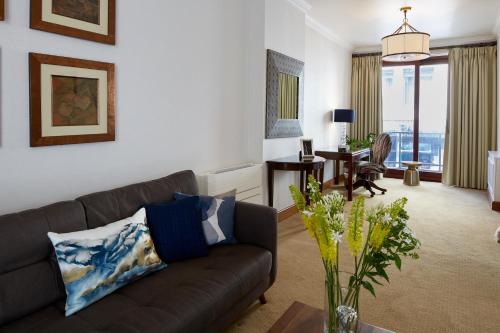 a living room with a couch and a table at Cheval Knightsbridge in London