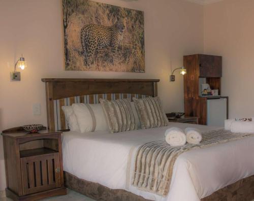 a bedroom with a bed with two towels on it at Mawusi Bush Lodge in Hoedspruit