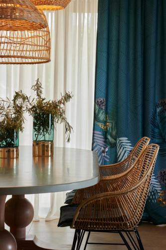 a dining room with a table and two chairs at Artblue Villas in Tsoukaladhes
