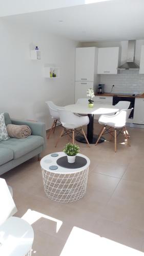 a living room with a couch and a table at Terrasses de Malmedy F&L triplex 214 et studio 320 et 317 et Studio supérieur 340 in Malmedy
