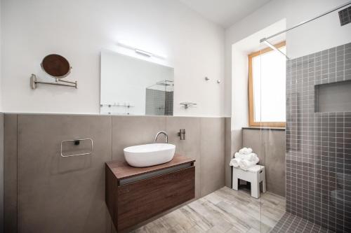 a bathroom with a sink and a shower with a mirror at B&B PROCHYTEA in Procida
