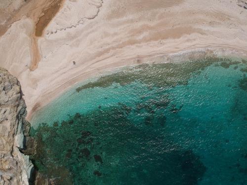 an aerial view of a beach with a body of water at Vitali Beach Houses in Andros