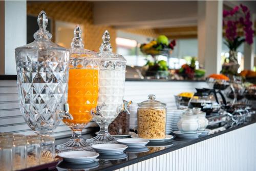 a counter with glass vases and jars of food at Napheera Royal Tel in Ban Khlong Bang Krathiam