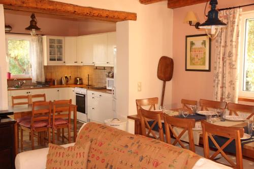 a kitchen and living room with a table and chairs at STONE ROSE VILLA in Agios Ioannis