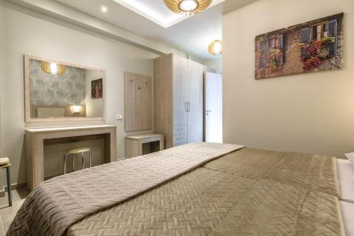 a bedroom with a large bed and a fireplace at Villa Regina in Keri