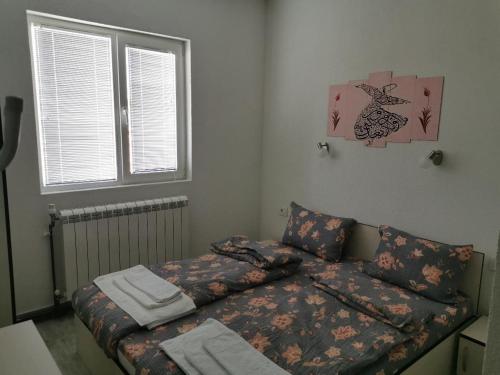 a living room with a couch and a bed at Diva Kompani Rooms in Berovo