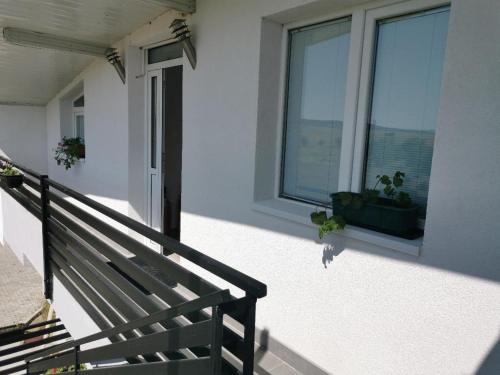 a balcony with a bench and a window with a potted plant at Diva Kompani Rooms in Berovo