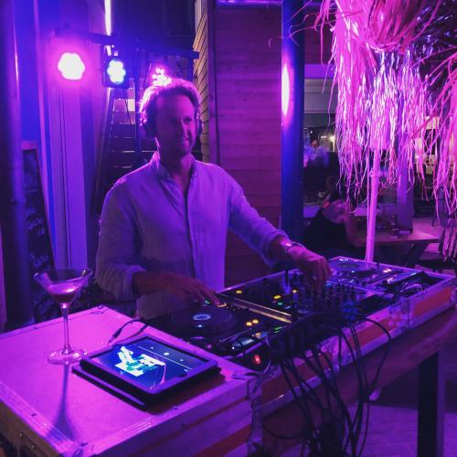a man standing at a table in a room at feels Beach Club Hotel in Kühlungsborn