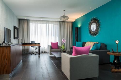 a living room with blue and pink walls and a desk at Radisson Blu Hotel, Nairobi Upper Hill in Nairobi