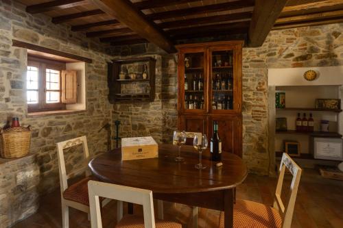 a dining room with a wooden table and chairs at Podere Cerretino in Poppi